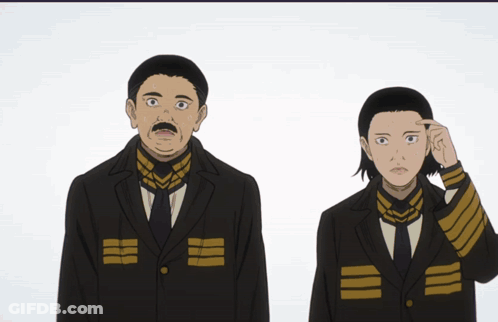 A Man With A Mustache Is Standing Next To A Woman In A Black Suit GIF