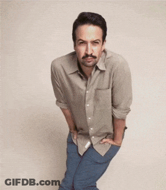 A Man With A Mustache Is Standing With His Hands On His Hips GIF