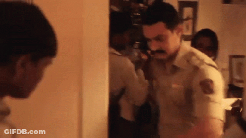 A Man With A Mustache Is Talking On A Phone GIF