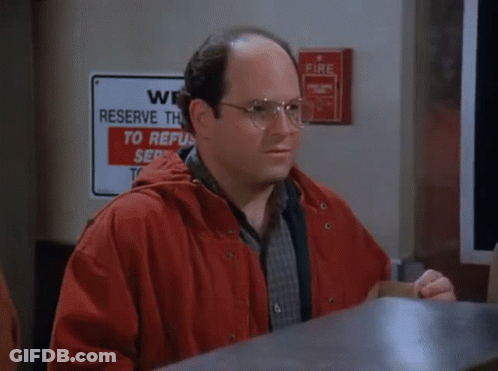 A Man With A Mustache Is Talking On A Phone While Another Man Writes On A Piece Of Paper GIF