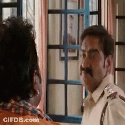 A Man With A Mustache Is Talking To Another Man . GIF