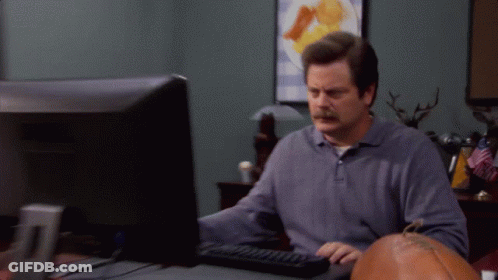 A Man With A Mustache Is Typing On A Keyboard In Front Of A Computer Monitor GIF