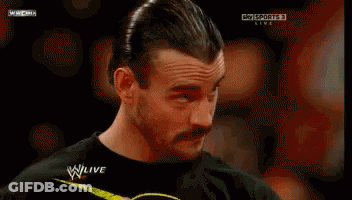 A Man With A Mustache Is Watching A Wrestling Match On Sky Sports Live GIF