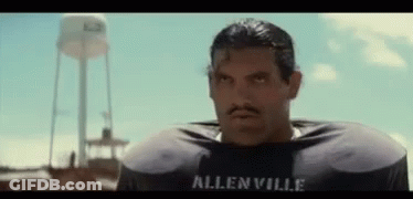 A Man With A Mustache Is Wearing A Allenville Football Jersey GIF