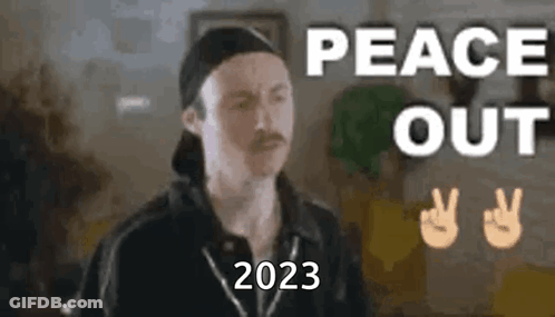 A Man With A Mustache Is Wearing A Baseball Cap And Making A Peace Sign . GIF