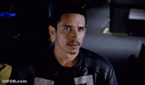 A Man With A Mustache Is Wearing A Black Leather Jacket And A Black Shirt . GIF