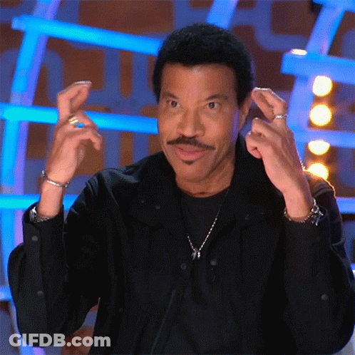 A Man With A Mustache Is Wearing A Black Shirt And Making A Funny Face GIF