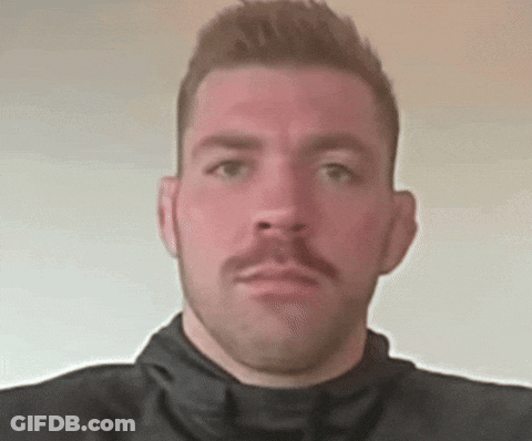 A Man With A Mustache Is Wearing A Black Turtleneck GIF