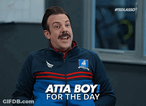 A Man With A Mustache Is Wearing A Blue Jacket That Says Atta Boy For The Day GIF