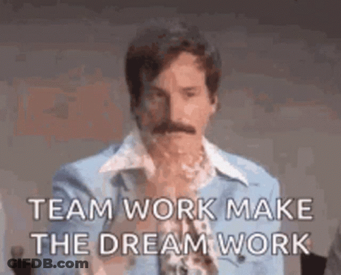 A Man With A Mustache Is Wearing A Blue Shirt And A Blue Jacket And Says `` Team Work Make The Dream Work '' . GIF