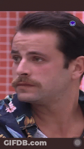 A Man With A Mustache Is Wearing A Blue Shirt GIF