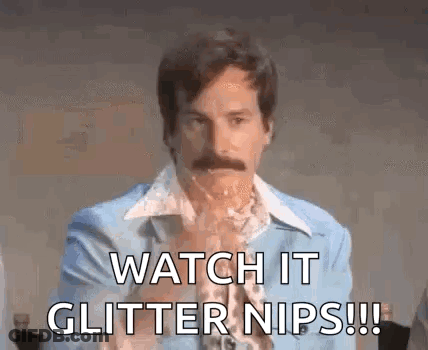 A Man With A Mustache Is Wearing A Blue Suit And Saying Watch It Glitter Nips . GIF