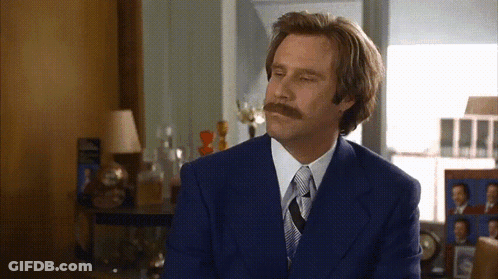 A Man With A Mustache Is Wearing A Blue Suit GIF