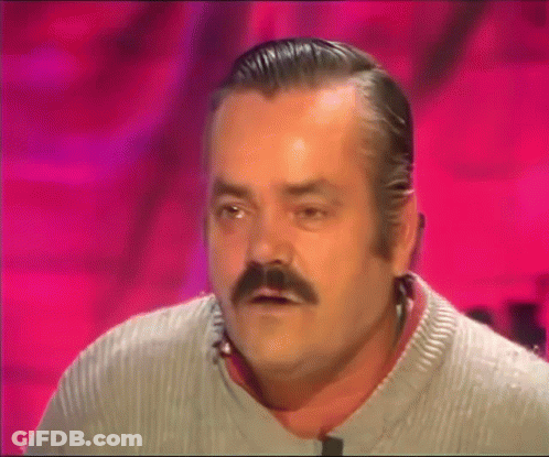 A Man With A Mustache Is Wearing A Grey Sweater And Making A Funny Face GIF