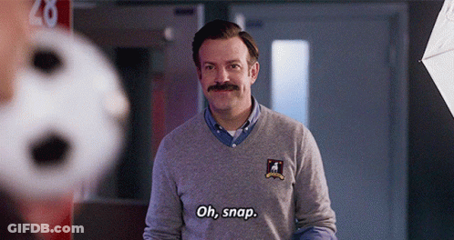 A Man With A Mustache Is Wearing A Grey Sweater And Says Oh Snap GIF