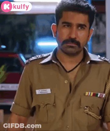 A Man With A Mustache Is Wearing A Police Uniform And Looking At The Camera GIF