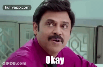 A Man With A Mustache Is Wearing A Purple Shirt And Tie And Says Okay . GIF
