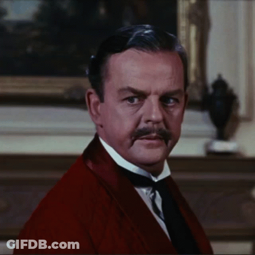 A Man With A Mustache Is Wearing A Red Jacket And Tie GIF