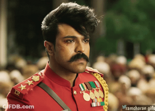 A Man With A Mustache Is Wearing A Red Uniform With Medals On The Sleeves GIF