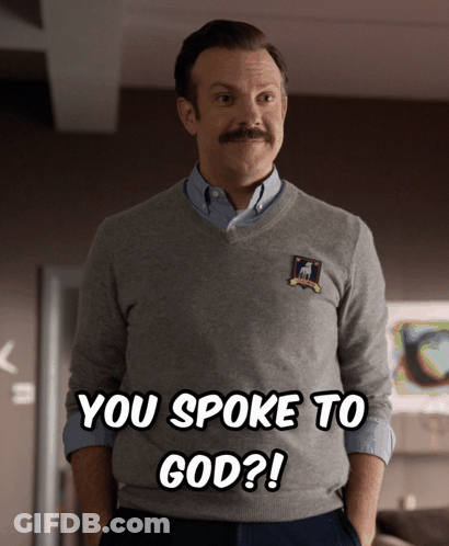 A Man With A Mustache Is Wearing A Sweater That Says You Spoke To God On It GIF