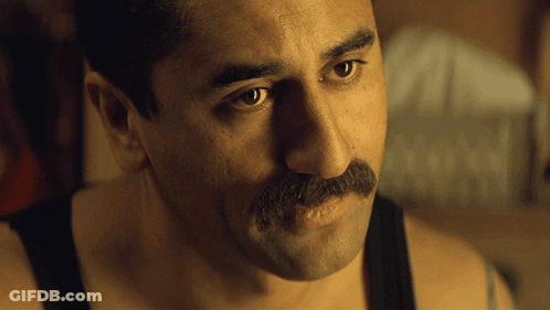 A Man With A Mustache Is Wearing A Tank Top GIF