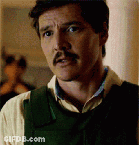 A Man With A Mustache Is Wearing A Vest And A White Shirt . GIF