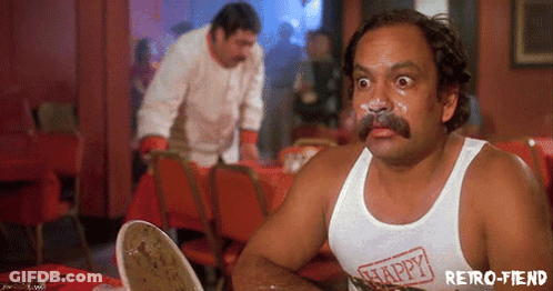 A Man With A Mustache Is Wearing A White Tank Top That Says Happy On It GIF