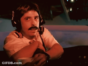 A Man With A Mustache Is Wearing Headphones And A Headset GIF