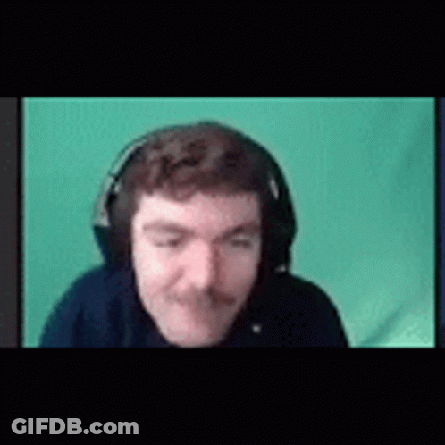 A Man With A Mustache Is Wearing Headphones And Making A Funny Face . GIF