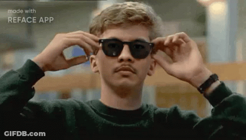 A Man With A Mustache Is Wearing Sunglasses And A Black Sweater . GIF