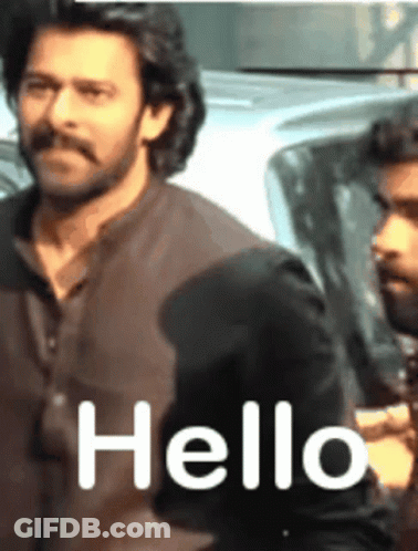 A Man With A Mustache Says Hello To Another Man GIF