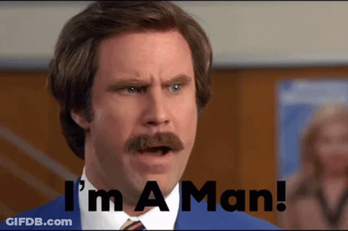A Man With A Mustache Says " I 'M A Man " In Front Of Him GIF