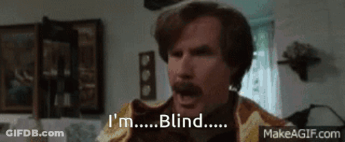 A Man With A Mustache Says I 'M Blind In A Living Room . GIF