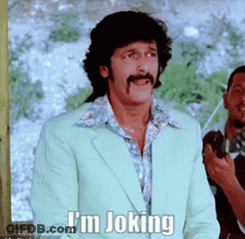 A Man With A Mustache Says I 'M Joking In A Green Suit GIF