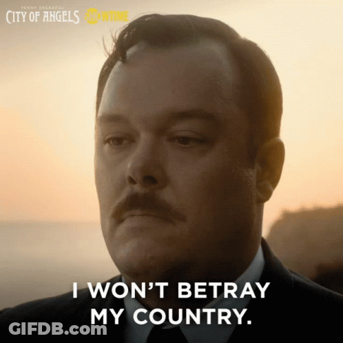 A Man With A Mustache Says " I Won 'T Betray My Country " In Front Of A Sunset GIF