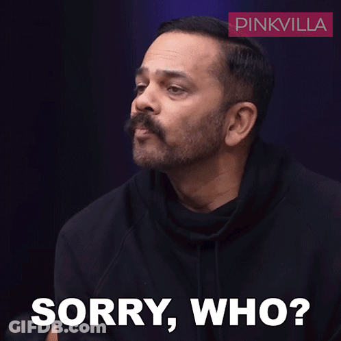 A Man With A Mustache Says Sorry Who In Front Of A Pinkvilla Logo GIF