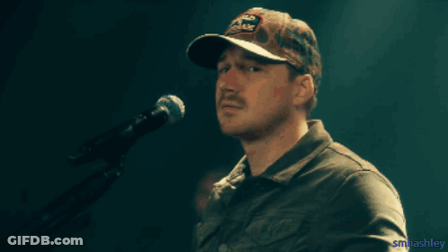 A Man With A Mustache Wearing A Hat That Says Old Dominion GIF