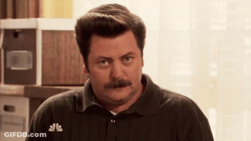 A Man With A Mustache Wearing A Nbc Polo Shirt GIF
