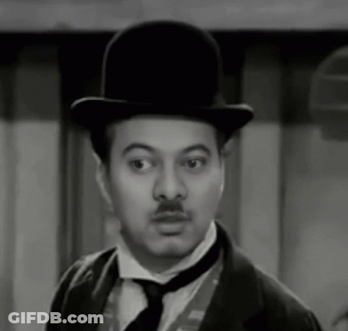 A Man With A Mustache Wearing A Top Hat And Tie GIF