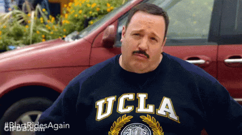 A Man With A Mustache Wearing A Ucla Shirt GIF