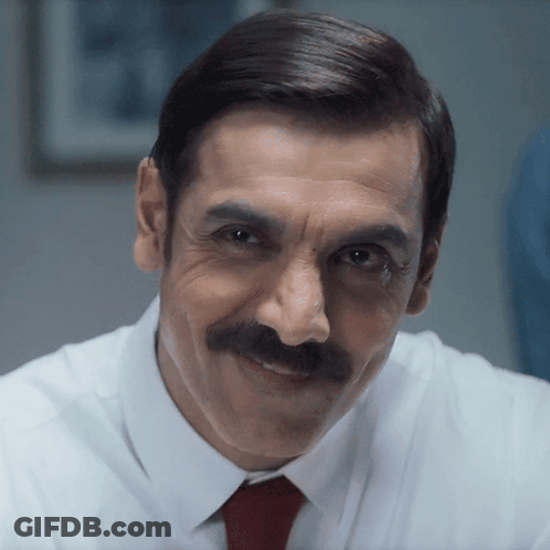 A Man With A Mustache Wearing A White Shirt And A Red Tie GIF