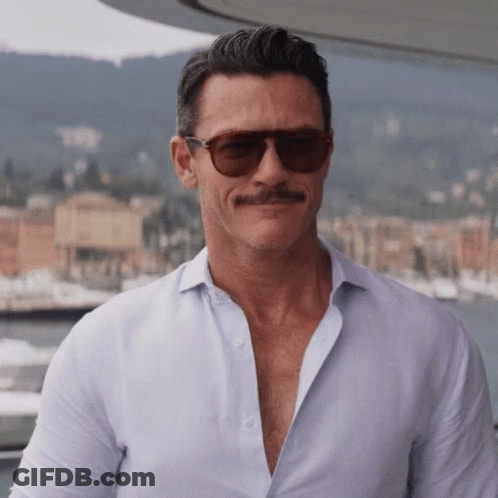 A Man With A Mustache Wearing Sunglasses And A White Shirt GIF
