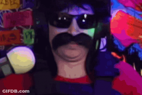 A Man With A Mustache Wearing Sunglasses And Holding A Microphone GIF