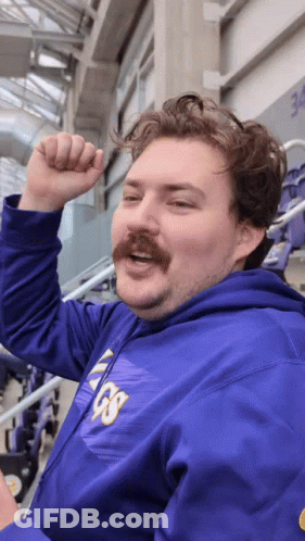 A Man With A Mustache Wears A Purple Vikings Hoodie GIF