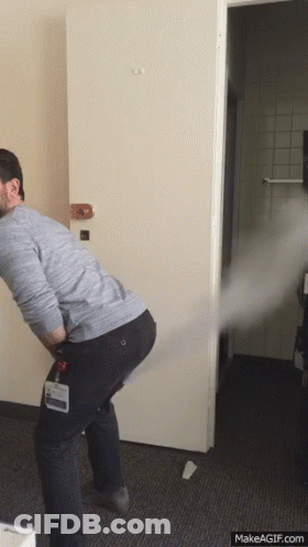 A Man With A Name Tag That Says ' Chris ' On It Is Standing In Front Of A Door GIF