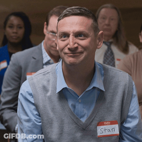 A Man With A Name Tag That Says Hello Stan GIF
