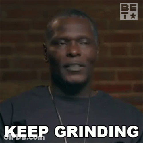 A Man With A Necklace Is Making A Funny Face And Saying `` Keep Grinding '' . GIF