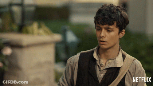 A Man With A Netflix Logo On The Bottom Of His Shirt GIF