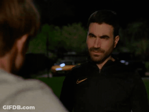 A Man With A Nike Logo On His Jacket Is Looking At Another Man GIF