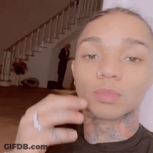 A Man With A Nose Ring And A Tattoo On His Neck Is Taking A Selfie . GIF